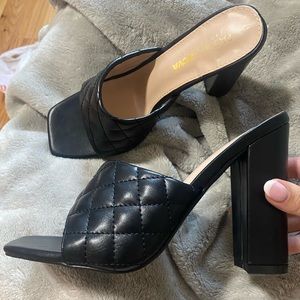 Never worn Black quilted high heels